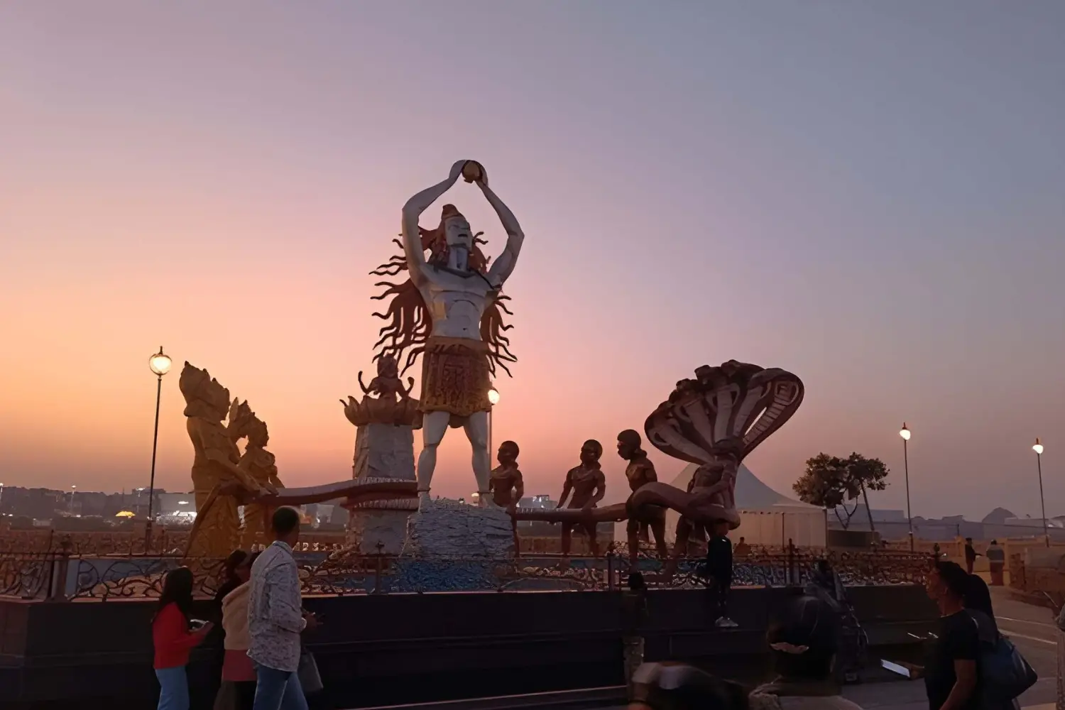 Sculptures at Shri Mahakal Lok silhouetted against the evening sky