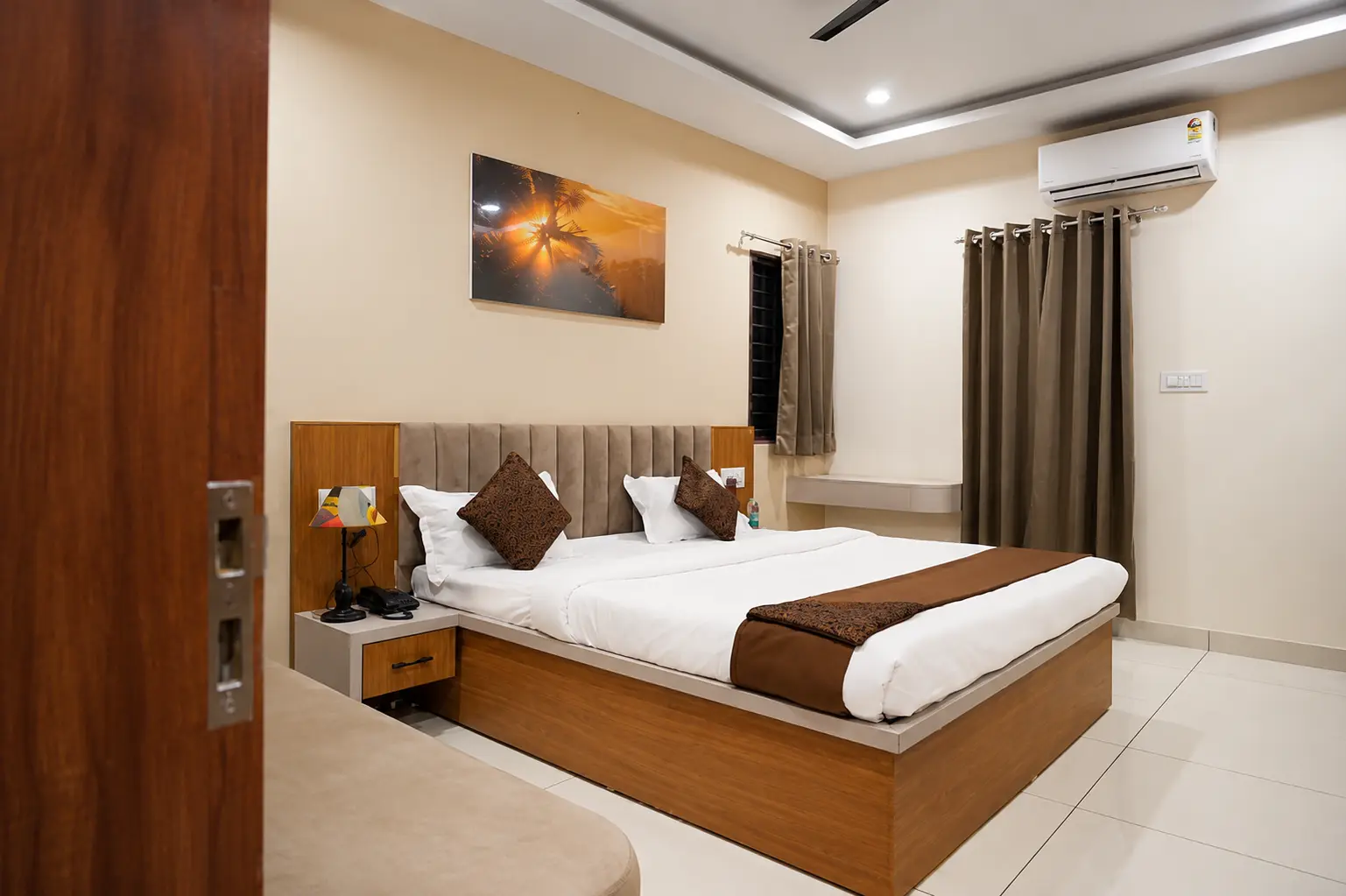 Deluxe Room at Shivkunj with a king-size bed, cushions and warm lighting